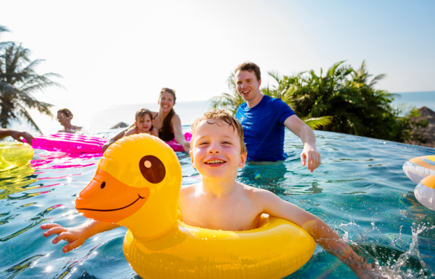 Familie spielt am Pool und Töchter und Vater spielen herum